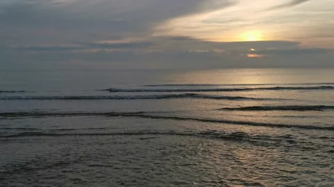 Small waves of water streaming in to the beach during the morning sunrise. Stock Footage 134186785