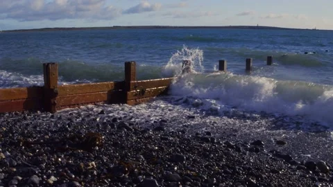 Small waves waves breaking on beach groin. Stock Footage 141112232