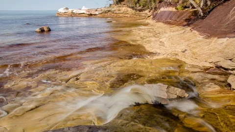 Small waves on yellow sandstone Stock Footage 100138698