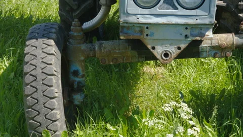 The small wheels of an old car on the field Stock Footage 241599895