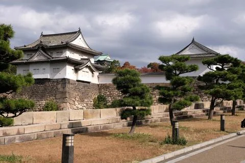 Small white architectural structures perched atop a red brick wall in an urban s Foto stock