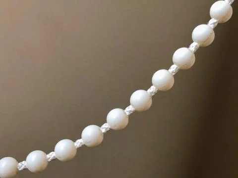 Small white balls lined up on the rope Stock Photos