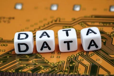 Small white beads cubes with word DATA placed on electronic circuit board Stock Photos