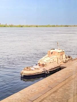 A small white boat juiling the obstacles of Esna, to control the territory,Egypt Stock Photos