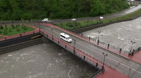 Small white bus drive on road bridge, over small cloudy water, slow down Stock Footage 63296259