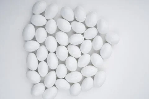 Small white candy on a white background Stock Photos