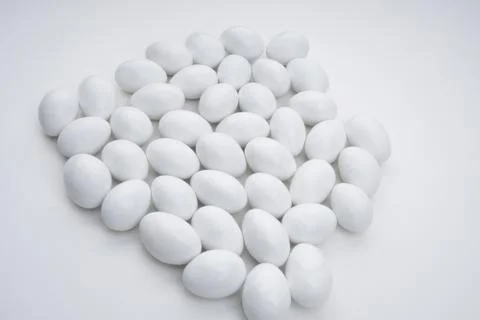 Small white candy on a white background Stock Photos