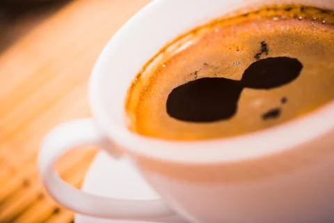 Small white ceramic coffee cup closeup. Fotos de archivo