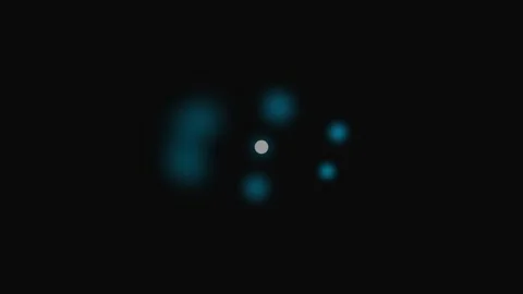 A small white circular icon surrounded by soft glowing blue light orbs Stock Footage 339617493