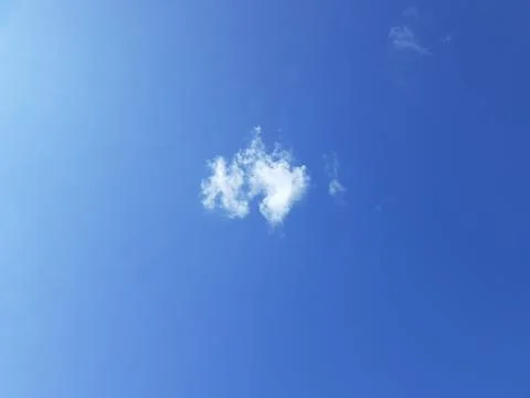 Small White Cloud in Blue Sky A clear sky background A cumulus cloud. Stock Photos
