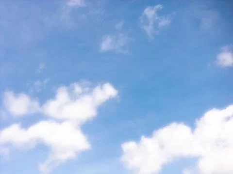 Small White Clouds Across a Bright Blue Daytime Sky Stock Photos