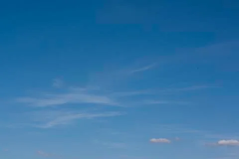 Small white clouds on blue sky Stock Photos