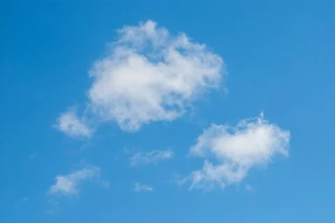 Small white clouds in peaceful blue sky Stock-Fotos