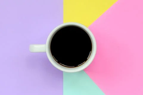 Small white coffee cup on texture background of fashion pastel blue, yellow,  Stock Photos
