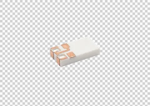 Small white electronic component with exposed copper pads on side isolated .. Fotos de archivo