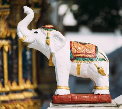 Small white elephant statue outside temple in Thailand. Stock Photos