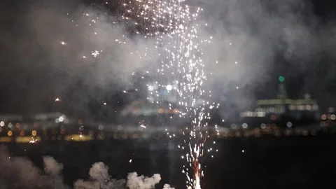 Small white firework burning and exploding - spreads sparkles Stock Footage 133026351