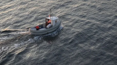 Small white motorboat sails fast along beautiful wavy water Video stock 119034925