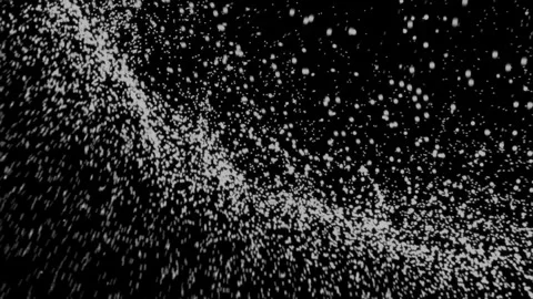 Small white particles flowing in circular pattern against black Stock Footage 327625029