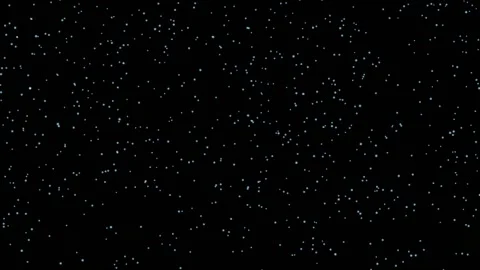 Small white particles move quickly and easily from the bottom up against a black Stock Footage 164633736