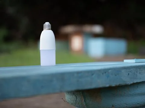 Small white plastic bottle standing on outdoor table Stock Photos