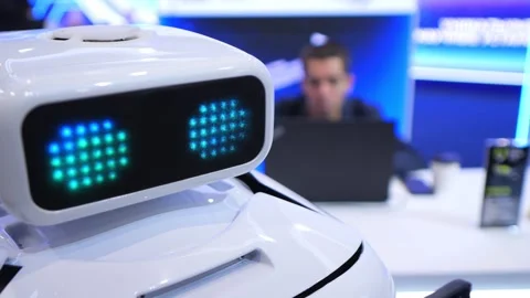 Small white robot with bright green LED eyes Stock Footage 344650175
