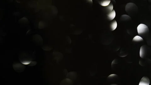 Small white round lights glow in the dark Stock Footage 142123478