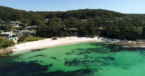 Small white sand Hyams beach and town in aerial turning as 4k. Stock Footage 138259963