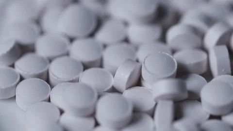 Small white tablets in close up Stock Footage 148470569