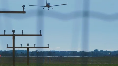 Small white training airplane with propeller engines landing at airport in Stock Footage 112989213