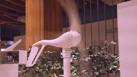 Small white wind turbine model spinning indoors for green energy demonstration. 動画素材 319208623