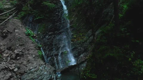 Small wild waterfall in the forest between cliffs Stock Footage 157734886