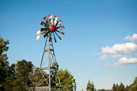 Small Windmill with Blue Sky and Clouds Stock Photos