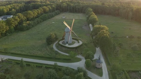 Small windmill in the field around woods in medieval village Stock Footage 123021169