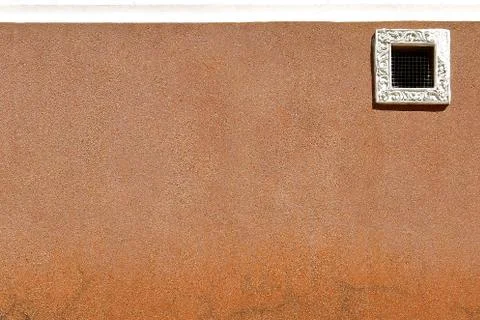 Small window and pebbledashed wall. Stock Photos