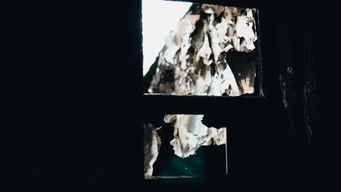 A small window in a broken, abandoned building. Broken glass Stock Footage 128016739