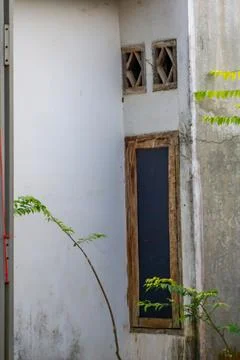 Small window in the corner of the house building, view from outside the house Stock Photos