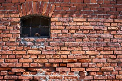 A small window in an old brick farm building in Bledzew Stock Photos