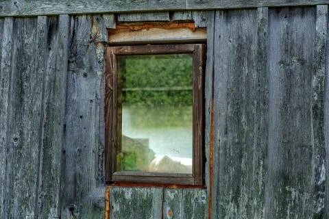 A small window in an old house. Stock Photos