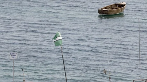 Small wooden boat, Devon flag bowing in the wind. Beer, England. Stock Footage 92687603