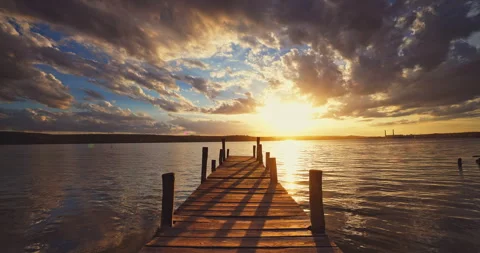 Small Wooden Dock and Boat at the lake and sunset cloudscape 4k timelapse video Stock Footage