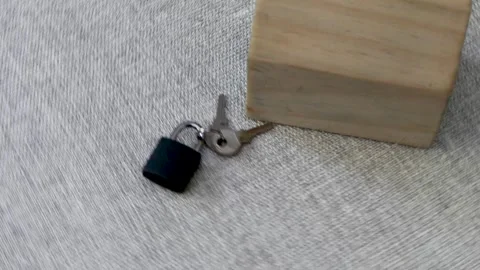 Small wooden house model with lock and keys rotating Stock Footage 248749751