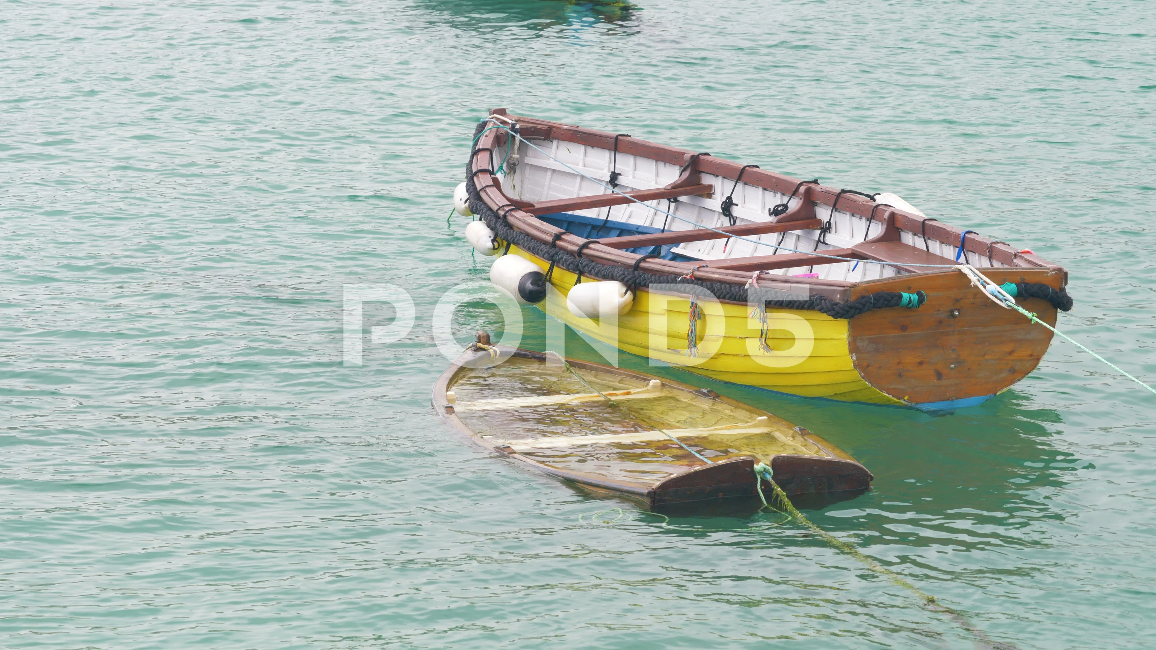 A small wooden rowing boat filled with w, Stock Video