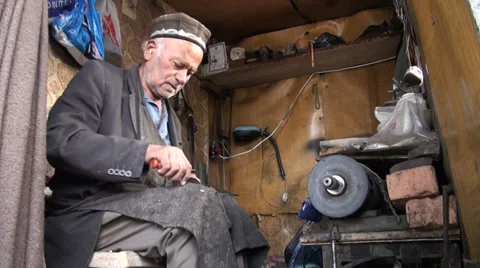 Small workshop of a shoemaker in Central Asia, poverty, traditional, small, work Video stock 28458161