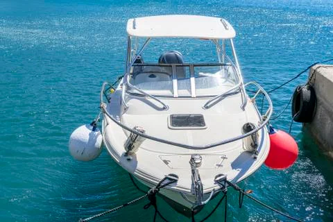 Small yacht docking in a harbor Stock Photos