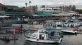 Small yachts and motorboats in Paphos harbor with cafe and shops on pier HD Footage