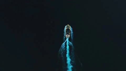 Small yellow boat sailing on the cold dark sea. Aerial top view Stock Footage 165226511