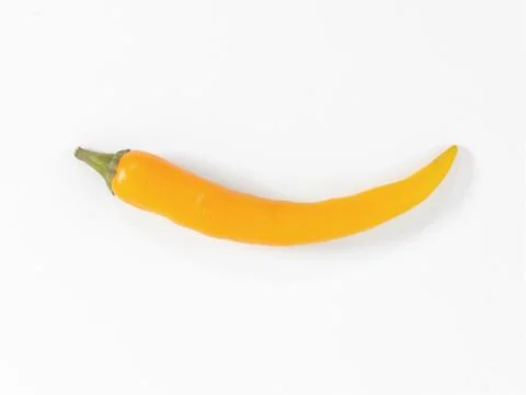 A small yellow chilli on a white background Stock Photos