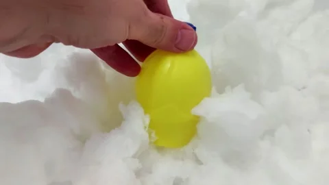 Small Yellow Plastic Container with Blue Cap Held Above Fresh Snow Surface 스톡 동영상 328906076