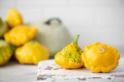 Small yellow squash on a wooden board Stock Photos